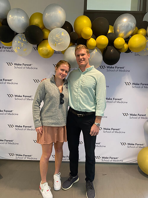 Two people standing side by side.