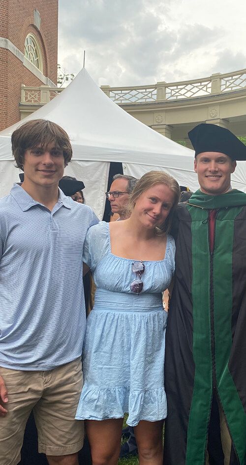 Three people standing side by side.