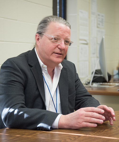 J. Mark Cline, DVM, PhD, DACVP, sits at a table and talks