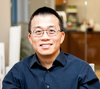 Mei-Chaun Ko, PhD, looks directly into the camera while sitting in his lab