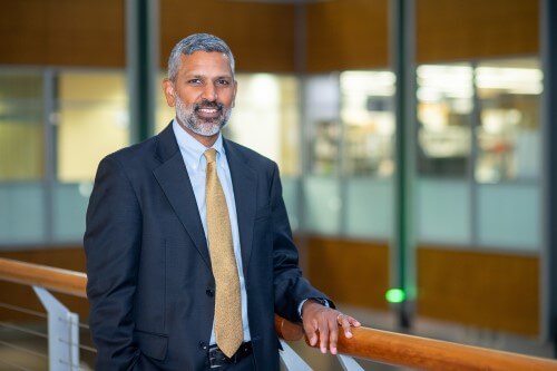 Deepak Palakshappa leaning on railing.