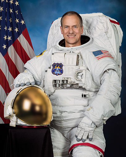 Thomas Marshburn, MD, smiling while wearing a spacesuit.