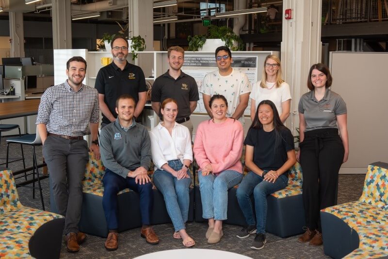 Group of 10 people posing for group photo.
