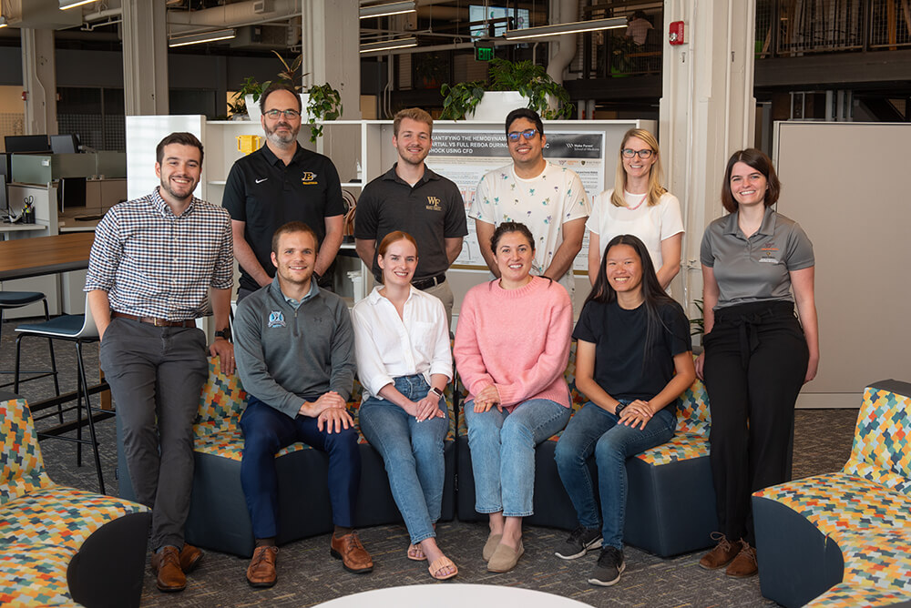 Research, hardware and software development contributors standing together for a group photo.