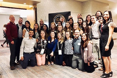 Group of Wake PA students and faculty pose together in common area at 2019 annual AAPA conference in Denver, Colorado