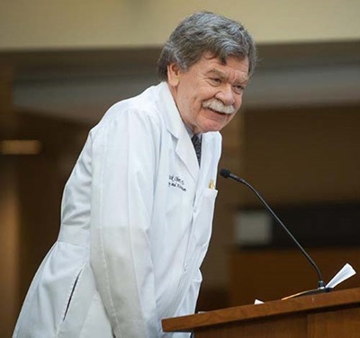 Wake PA professor and medical director, Pat Ober, MD, stands at podium during Class of 2021 White Coat Ceremony