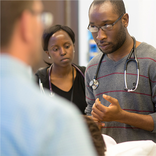 PA students interact with a standardized patient, a person trained to act out symptoms of various conditions