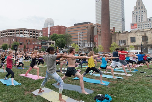 Students participate in outdoor yoga in Bailey Park