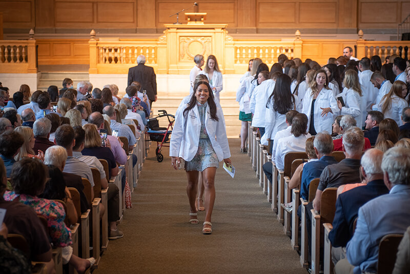Students exiting the white coat ceremony.