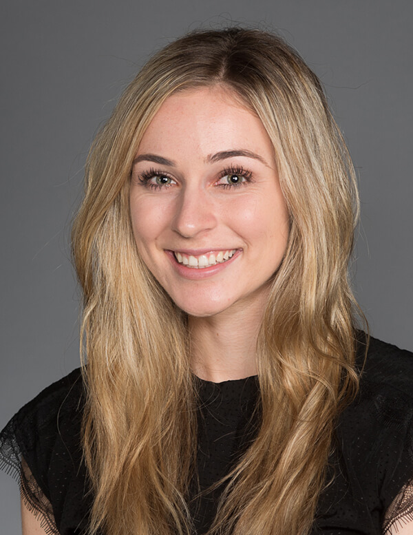 A woman with blonde hair smiling at the camera.