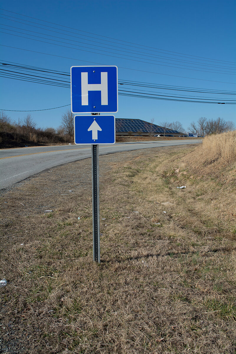 A photo of a hospital road sign.