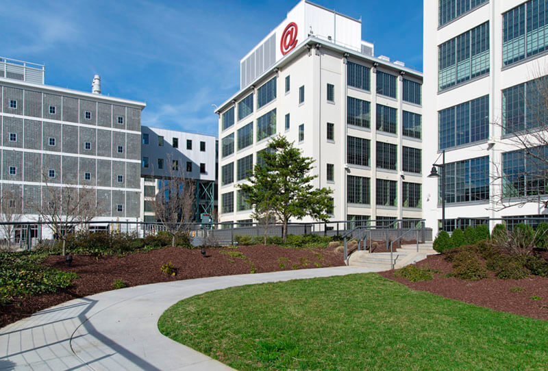 An exterior shot of several white, multi-story buildings.