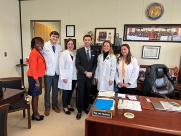 PA students, faculty and practicing PAs taking a group photo with a State Representative.
