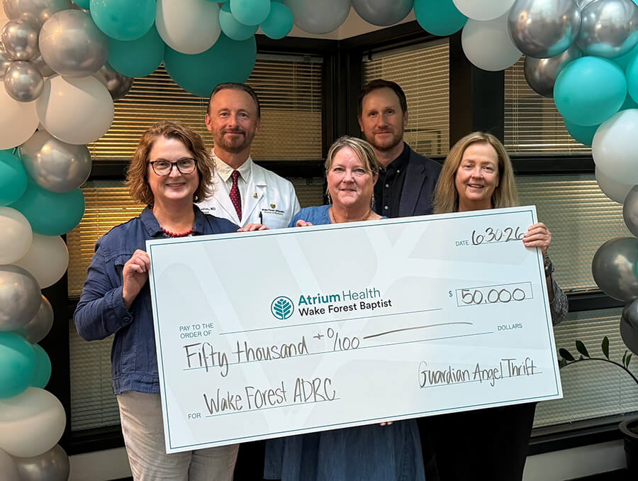 A group of people holding a large check.