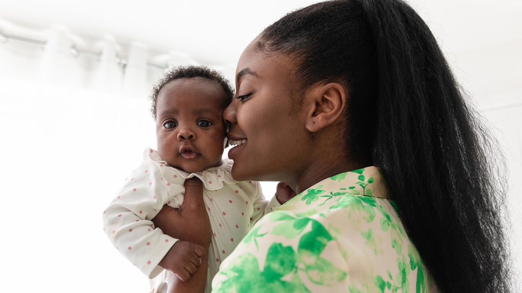 woman holding her baby close