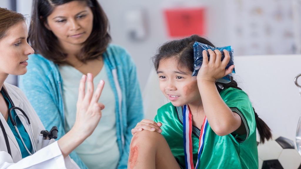 Child with icepack on head at doctors office 