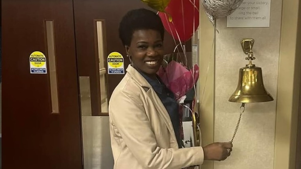 La Becky Roe ringing the bell after successful treatment.