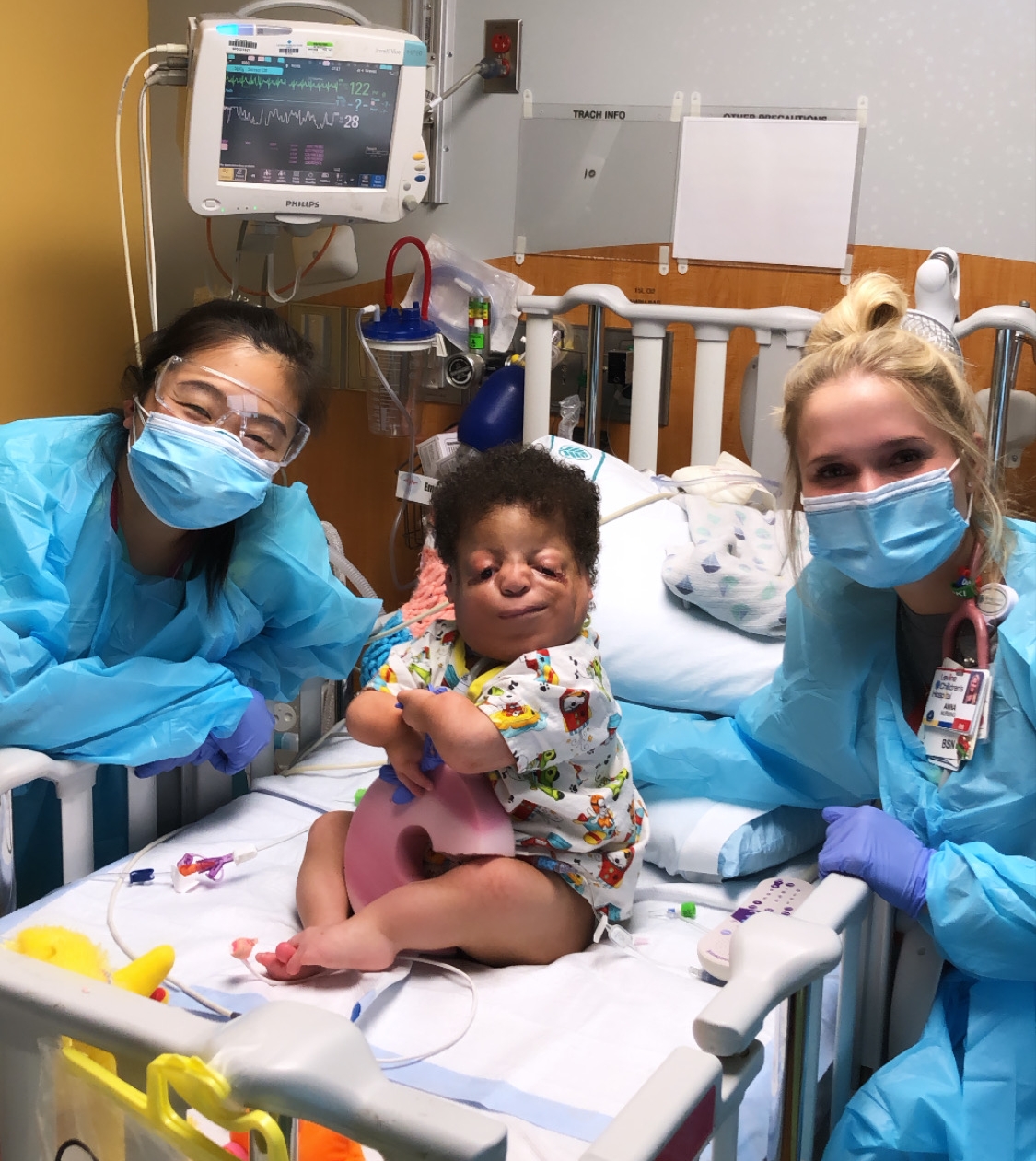 Austin shows off some of her hard-working teammates from the 8th floor. Here we have nurse practitioner, Katie, and nurse Anna with their patient Gabe.