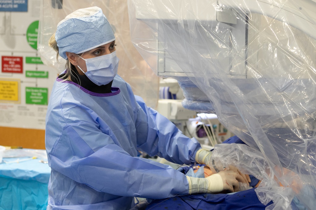 A woman wearing a surgical gown.