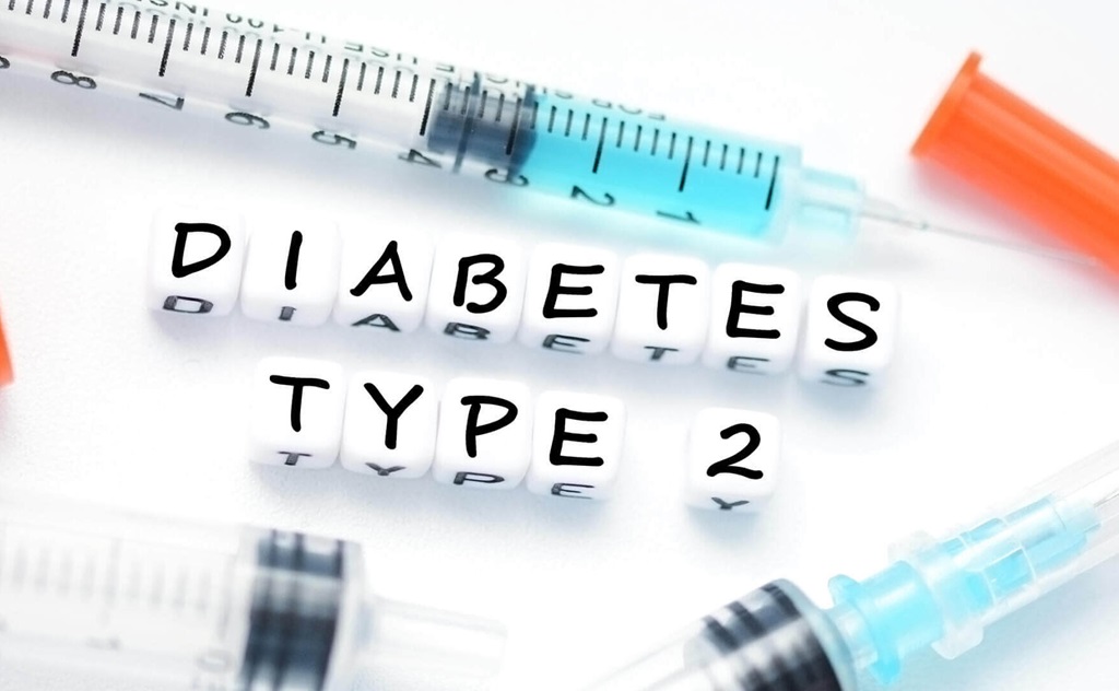 Syringes on a white background with dice spelling out "diabetes type 2".