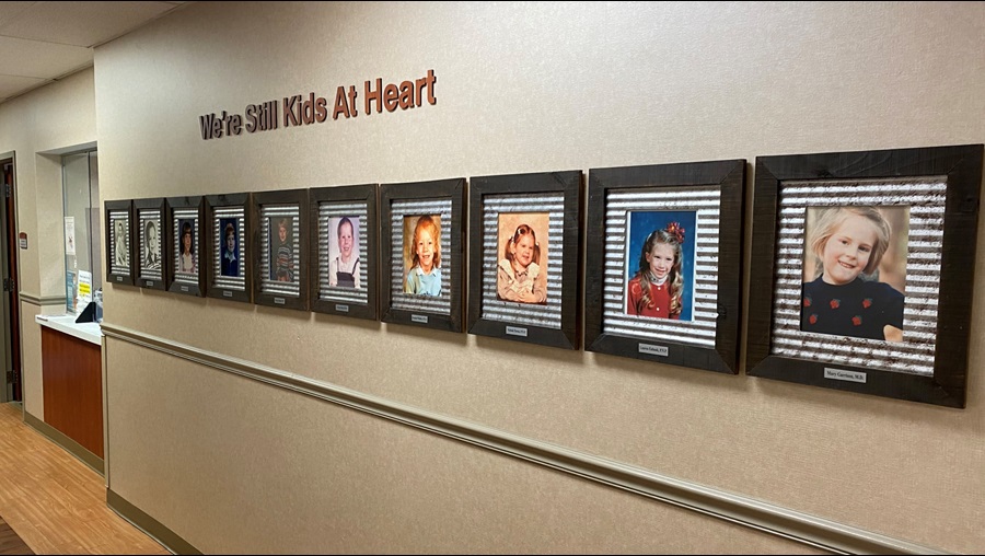 Series of physician childhood photos hanging in Atrium Health Levine Children's Cabarrus Pediatrics