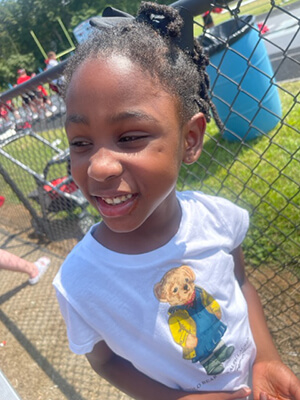 A young child smiling at the camera.