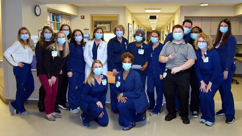 Maureen Swick poses with group of nurses at Atrium Health facility