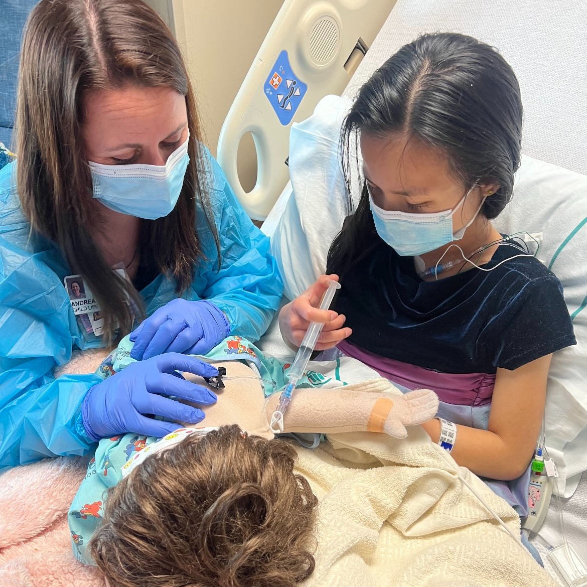 Andrea Westmoreland, certified child life specialist with patient, Gracelyn