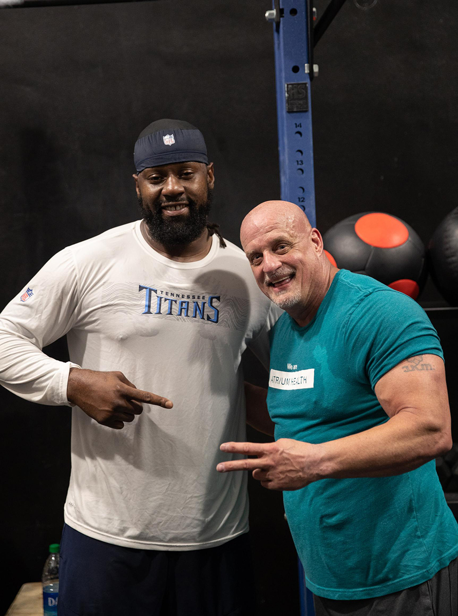 Denico Autry, defensive end for the Tennessee Titans, and Scott Brone, physical therapist and director of rehabilitation, pose during a rehab session at the YMCA.
