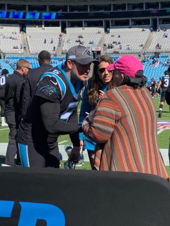 Levine Cancer Institute patient Melody Clark meeting Panthers players when gifted tickets to a game.