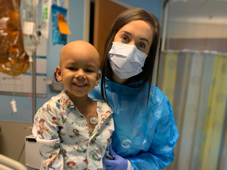 Sarah with one of her sweetest patients, Dominic. He's five years old, full of laughter, and currently getting treatment for Burkitt Lymphoma.  