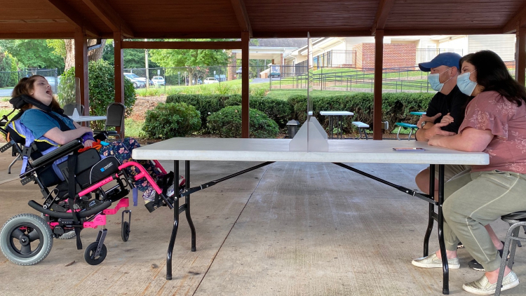 Dr. Ashley Sumrall and her husband, Rusty, visit their daughter at a long-term care facility for individuals with special needs under strict COVID-19 protocol. 