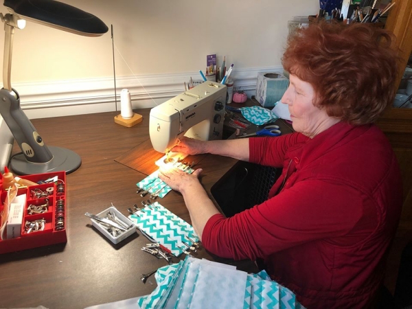 A local seamstress group, the Tree Top Needlecrafters, sews face masks to donate to Atrium Health during the coronavirus pandemic