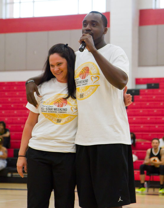 Omar Carter, right, speaks to a crowd while embracing Kelly Thomas, a cardiac intensive care unit nurse at Carolinas Medical Center, who helped save his life when he collapsed playing basketball two years ago. 