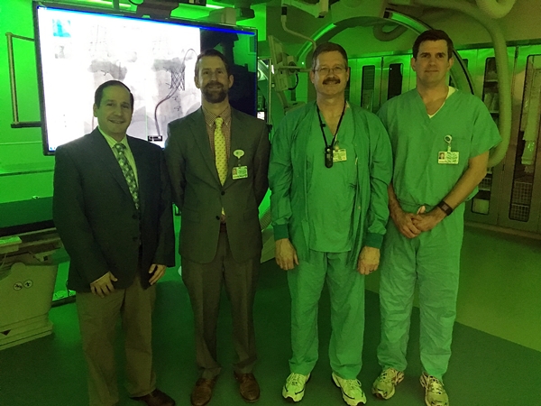 Joseph Paolillo, MD, pediatric cardiologist, Steve Wright, AVP of cardiovascular services, Tom Wilson, technical operations manager of surgical services, central division, and Chan Roush, VP, central division operations, review the new pediatric catheterization lab at Levine Children's Hospital. 