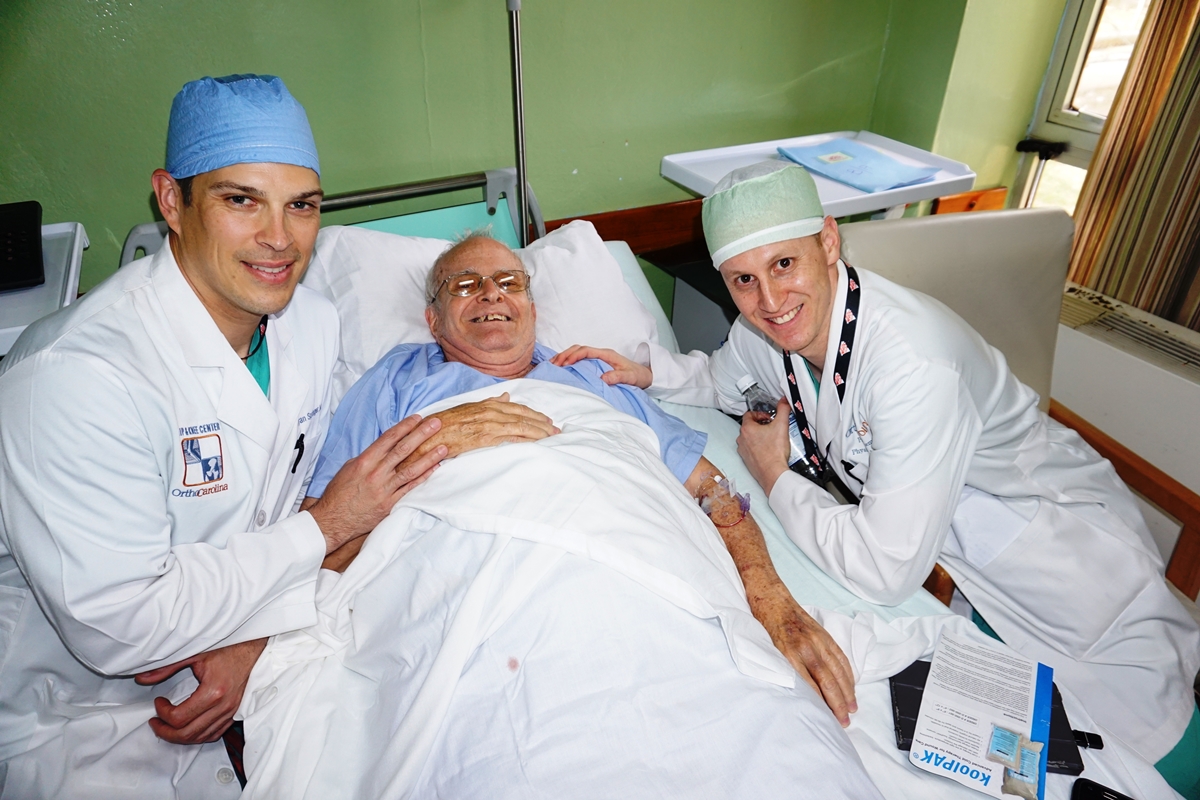 Operation Walk Carolinas founder Bryan Singer, MD (left), and Paul Coleman, PA, with a patient in Cuba.