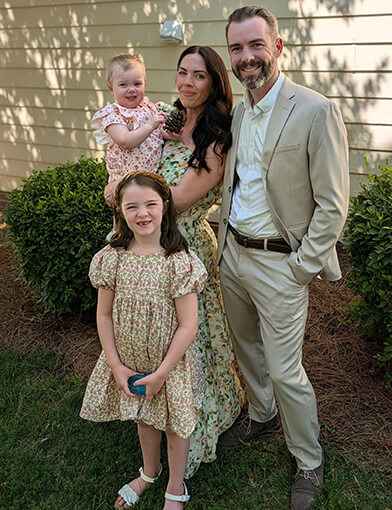 A young family and their two daughters.