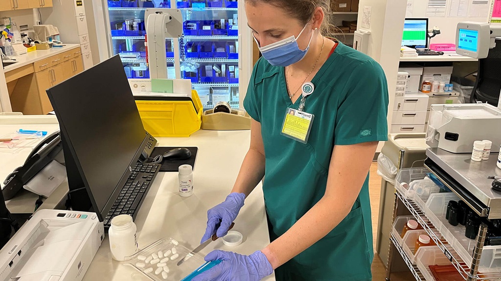 A medical professional counting medication.