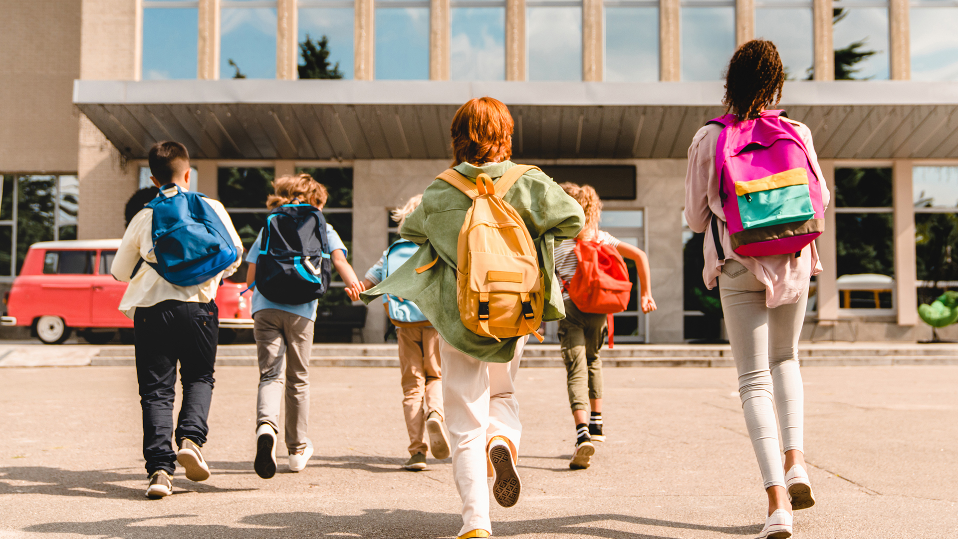 Children running into school for the first day of the school year