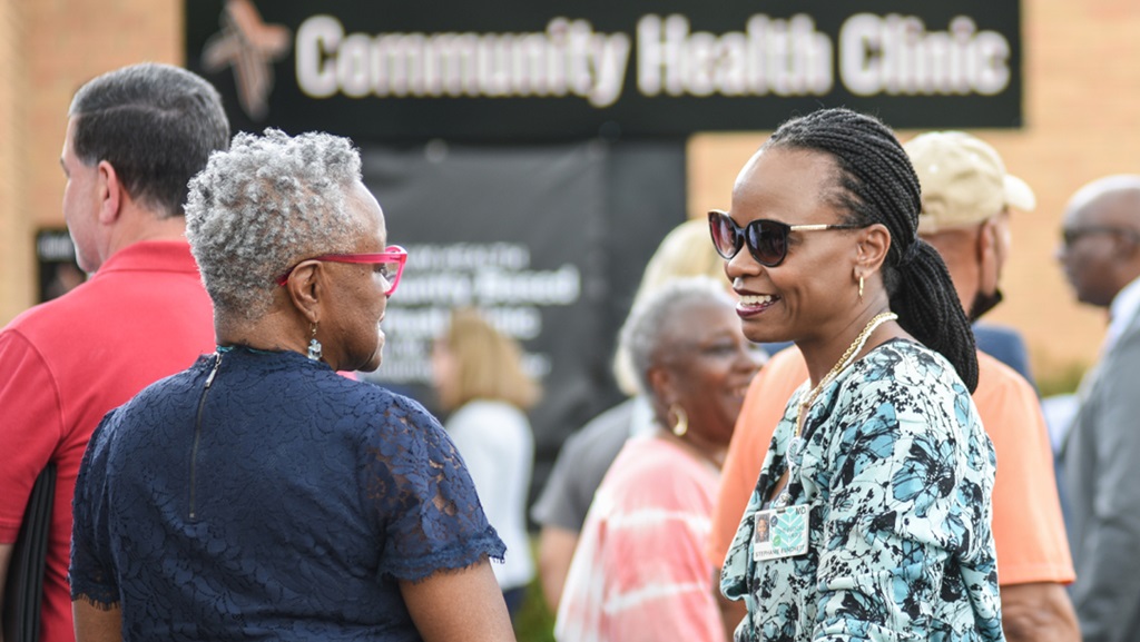 Atrium Health physician speaks with patient at community health clinic