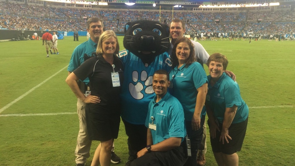 Connie and Atrium Health team at Carolina Panthers football game
