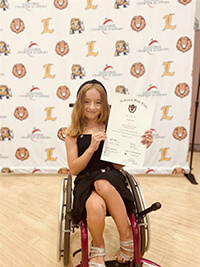 A child holding an award.