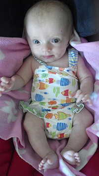 A baby looking at the camera.