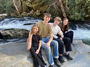 A family sitting by a waterfall.