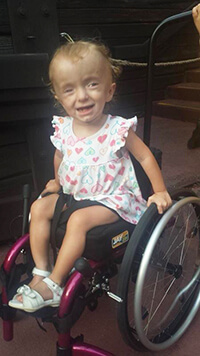 A child smiling at the camera.