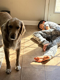 A child sleeping beside a dog.
