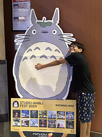 A child hugging a cartoon figure.