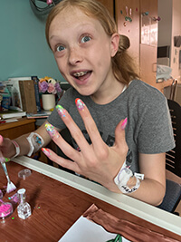 A child painting their nails.