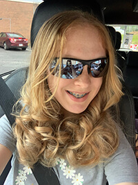 A child smiling at the camera.