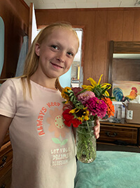 A child holding a bouquet of flowers.